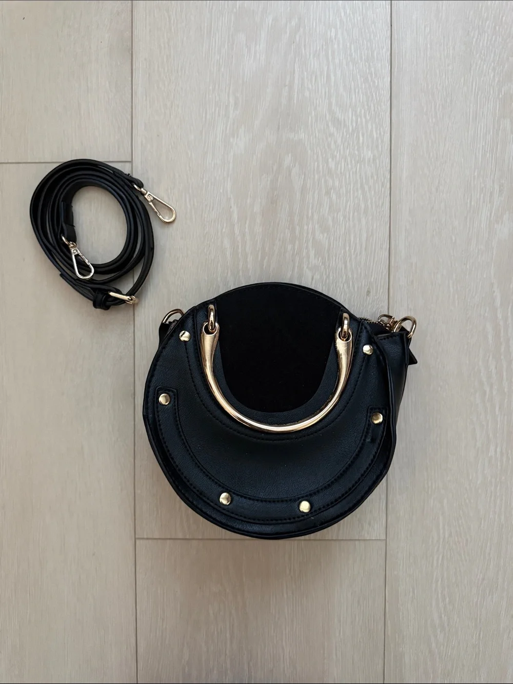 Black Round Crossbody Bag with Gold Accent Handle
